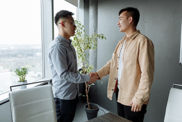 two people meeting and shaking hands
